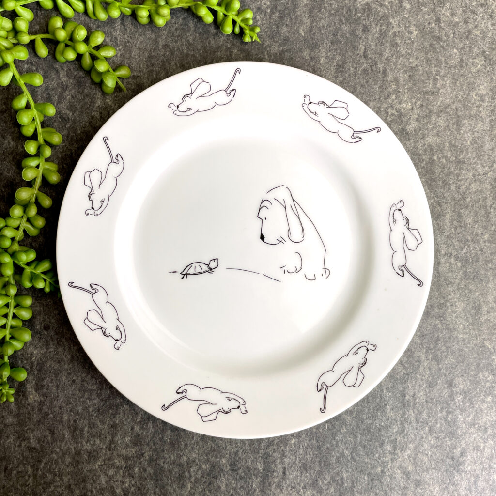 decorative plate with a James Thurber cartoon illustration of a dog and a turtle