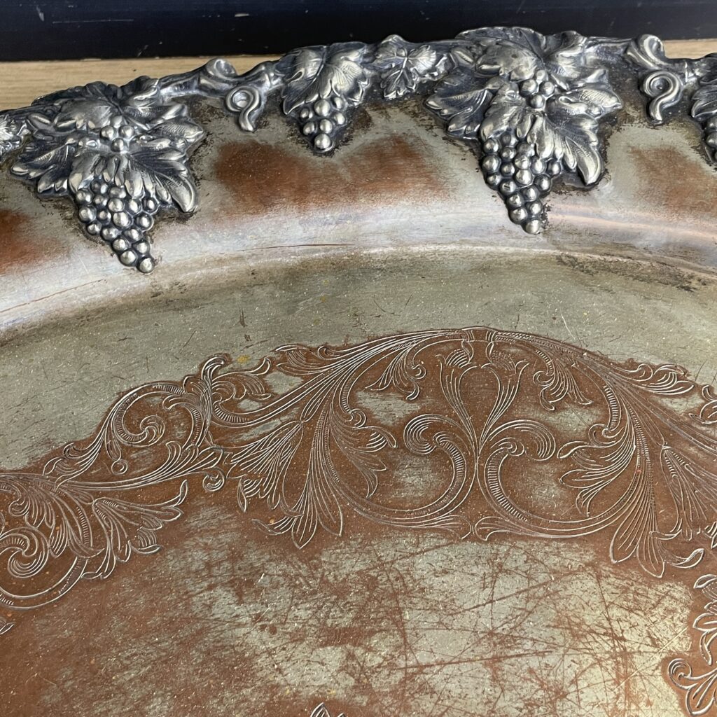 silver plate serving tray with the silver worn off showing the copper underneath.