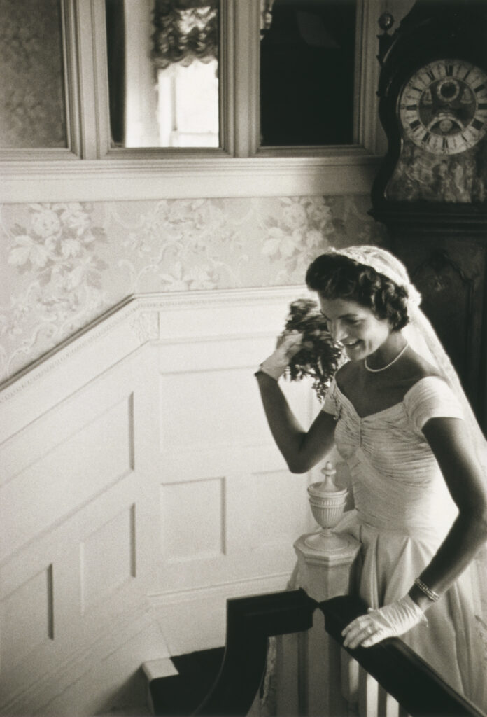 Jacqueline Kennedy throwing the bouquet at her first wedding