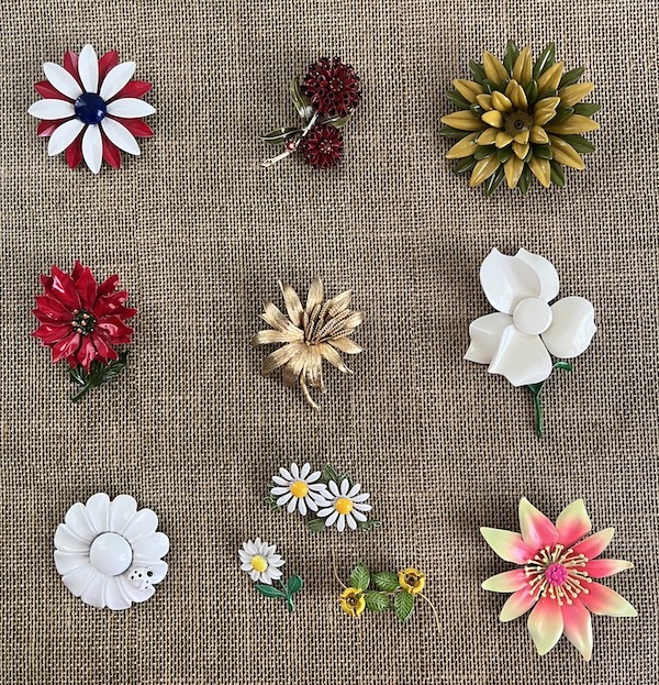 selection of flower power brooches
